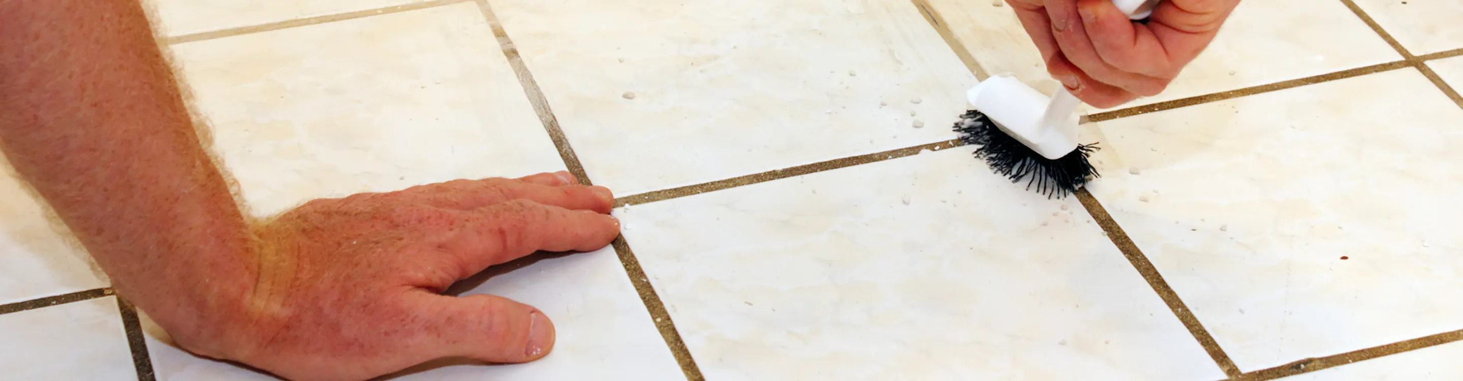Man cleaning tile